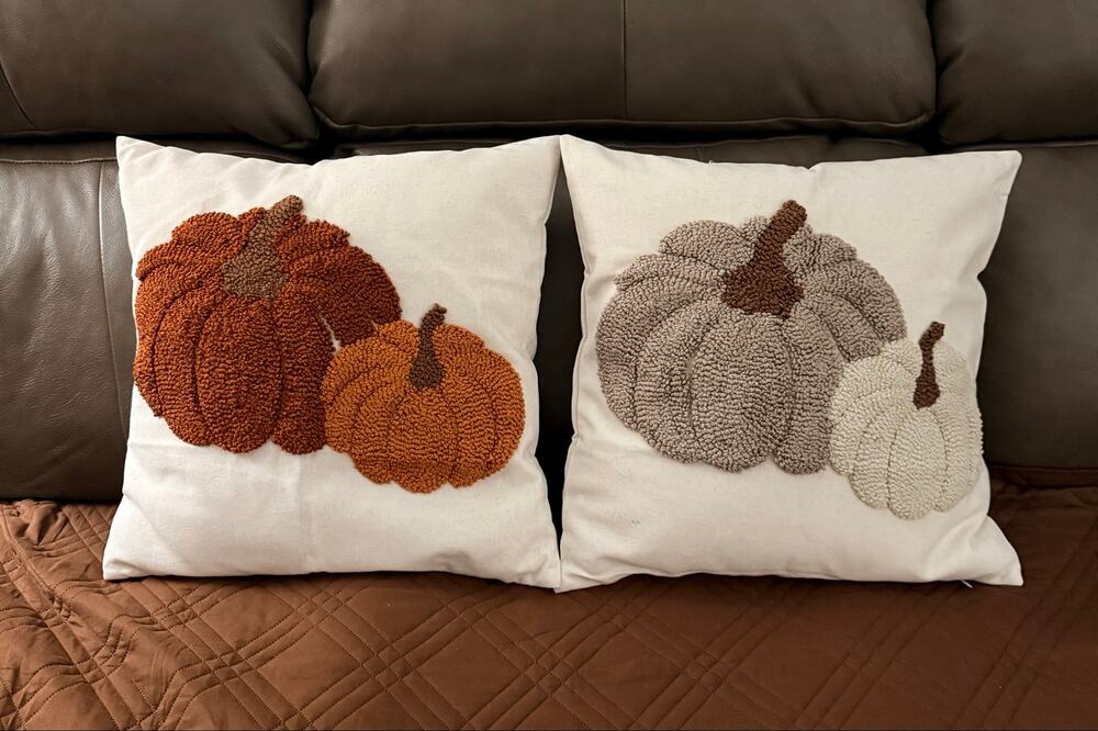Two new pumpkin throw pillows features a textured, loop-pile embroidered